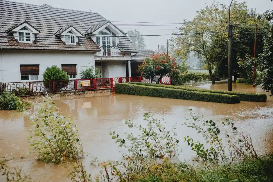 Flood water surrounding a house and yard after heavy rain